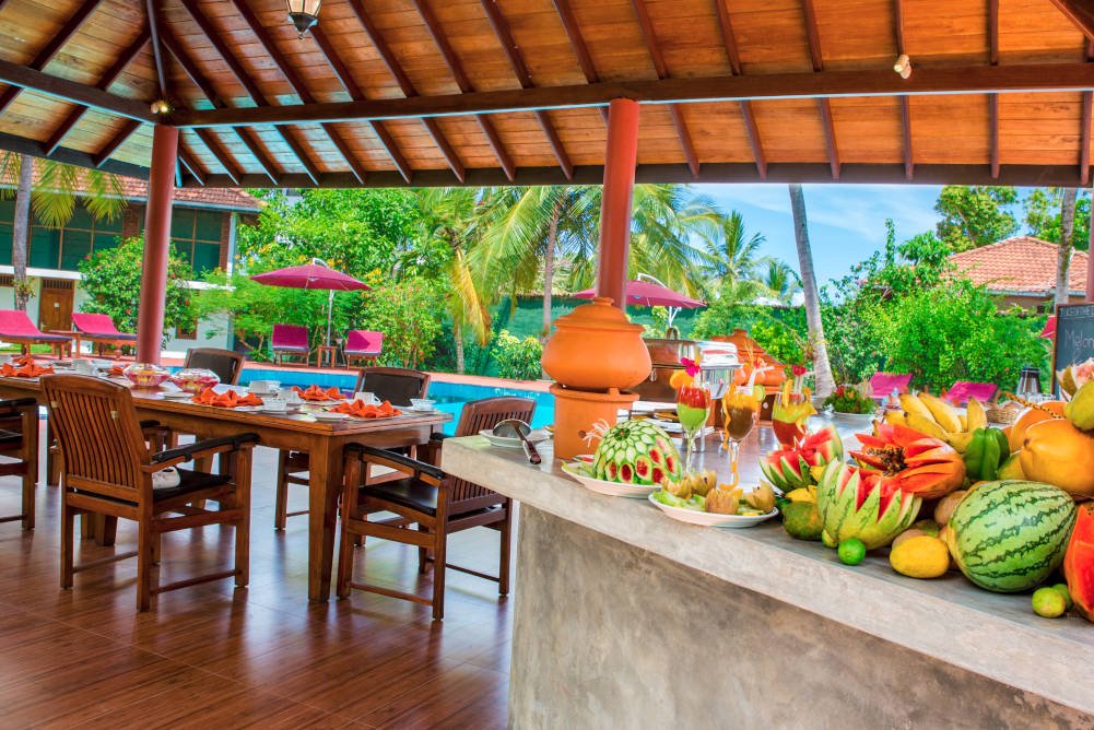 ayurvedic resort out door dining area with pool view bigger picture